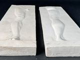 pair of white marble sculptures of a cat and a dog