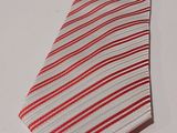 a red and white striped tie on a white table