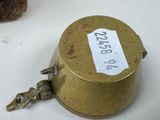 a small metal object with a tag on it