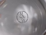 a close up of a silver plate with a clock on it