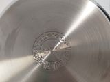 a large stainless steel frying pan on a wooden table