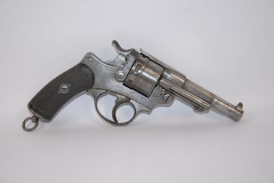 a silver revolver on a white surface with a white background