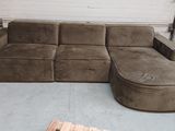 a couch that is sitting in a room with pallets on the floor