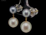 pair of pearl and gold earrings on a black background