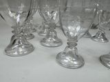 many empty wine glasses lined up on a table