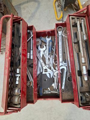 many tools in a red toolbox on the floor