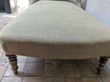 a chaise lounger sitting on a tiled floor