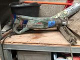 a drill that is sitting on top of a workbench