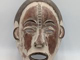 an image of a wooden mask with a painted face on it
