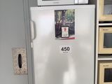 a refrigerator with a microwave on top of it in a kitchen