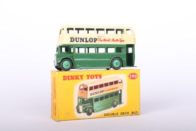 a green and white double decker bus on top of a box