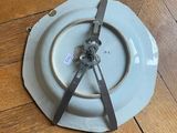 a white plate with a clock on it on a wooden floor