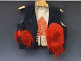 a red and blue vest hanging on a hanger