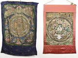 two wall hangings with a painting of a buddhist wheel and a painting of a buddhist wheel