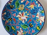 a blue plate with a floral design on it