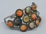 an image of a bracelet with multi colored stones on a white surface