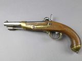 a close up of a gun on a table with a white background