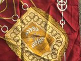 an image of a red and gold scarf with gold trims