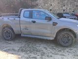 a truck that is parked in front of a stone wall