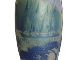 a blue vase with a painting on it on a white background