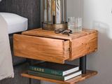 a small wooden table with a glass on top of it