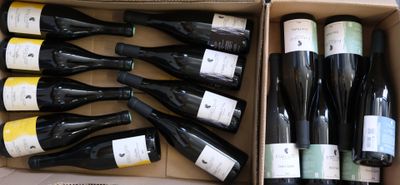 many bottles of wine in a box on the floor