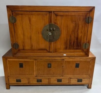 a wooden cabinet with a door on top of it