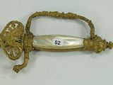 a gold sword with a number on it on a white surface