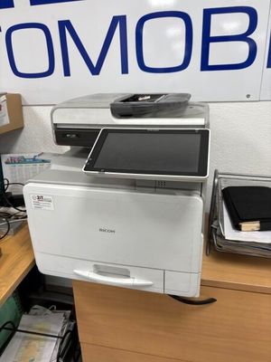 a printer sitting on top of a desk in a room