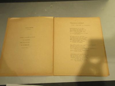 an open book on a table with papers on it