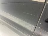 a close up of a car door with a hole in it