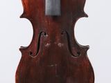 an old violin with a bow hanging from it ' s back