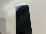 un téléphone portable noir posé sur une table à côté d'un ordinateur portable