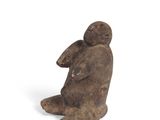 an image of a statue of a man sitting on his knees