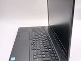 a laptop computer sitting on a table with a keyboard