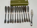a lot of silverware on a table with a green box