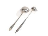 two spoons and a ladle on a white surface