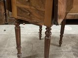 a small wooden table with a drawer on top of it