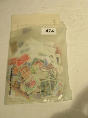 a bag of stamps sitting on a table next to a cell phone