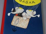 a book with a picture of a couple of mice flying in a balloon