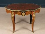a small table that has a red and gold decoration on it