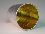 a close up of a metal cup on a white surface
