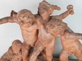 a statue of a group of children playing with a ball