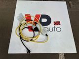 a white sign with a yellow cord attached to it