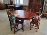 a wooden table and chairs in a room with a stone wall