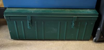 a green box sitting on the floor next to a blue box
