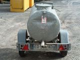 an image of a tank on a trailer parked in a parking lot
