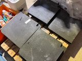 four pieces of concrete on a pallet in a room