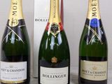 three bottles of champagne sitting next to each other on a table