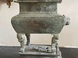 a statue of a bird sitting on top of a table